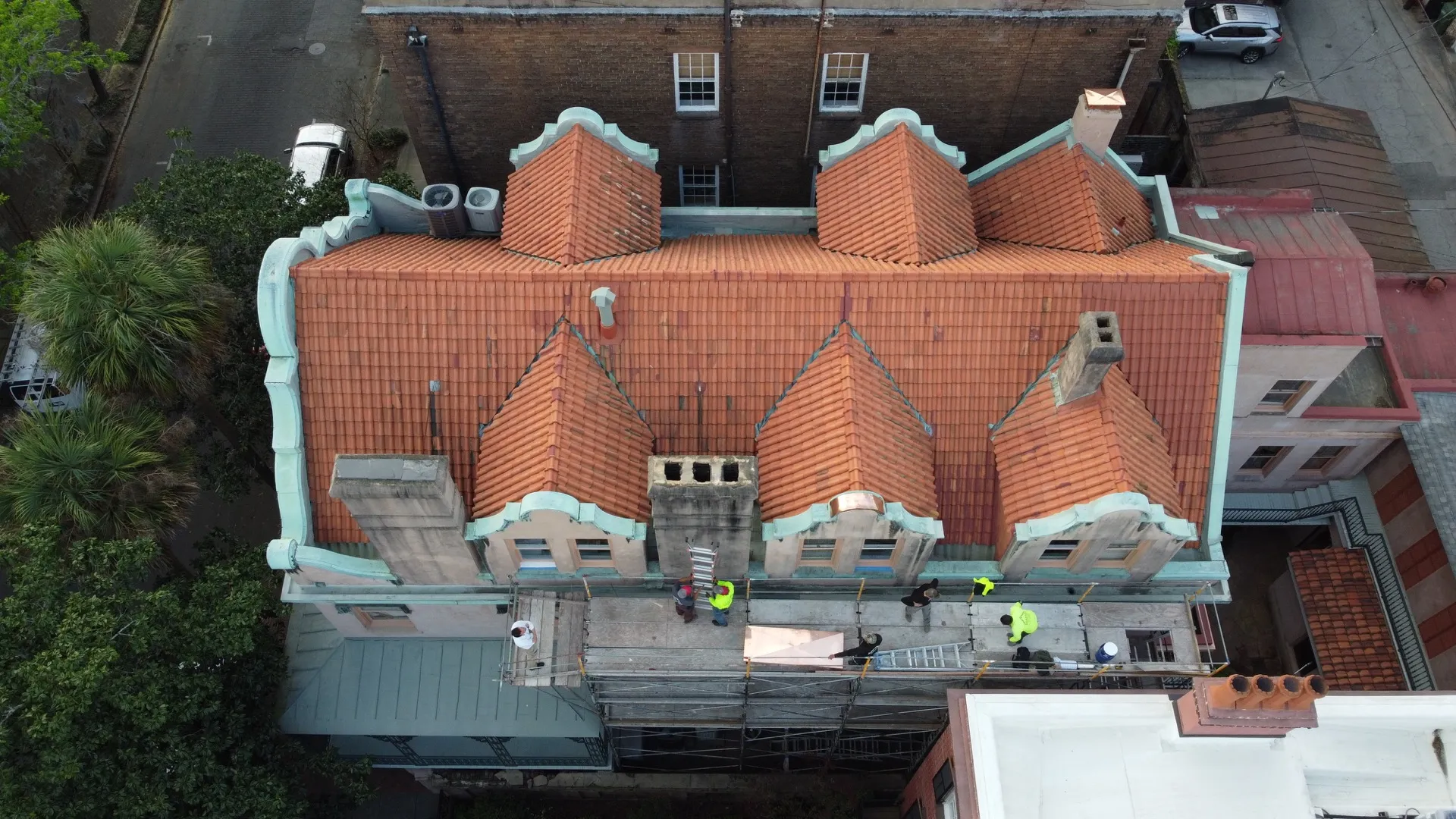 Coastal Roofworks crew restoring a tile and copper roof in historic Savannah